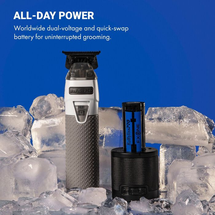 All-metal trimmer with white body and dark head beside battery charging canister.