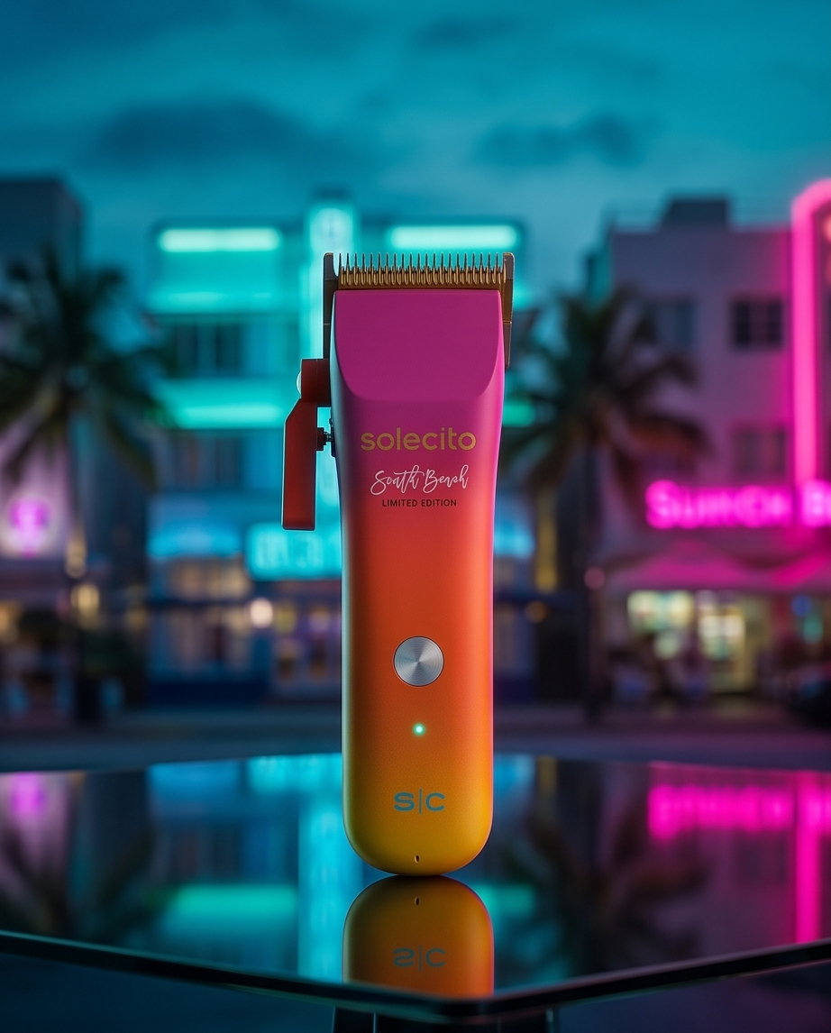 Professional hair clipper with purple cutting head and orange-to-yellow gradient body on reflective surface