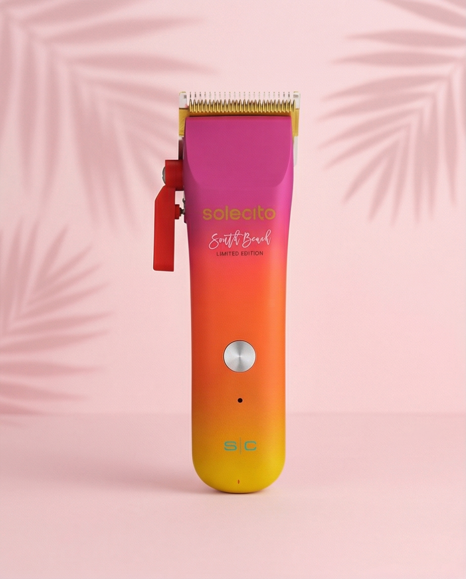 Professional hair clipper with purple cutting head and orange-to-yellow gradient body