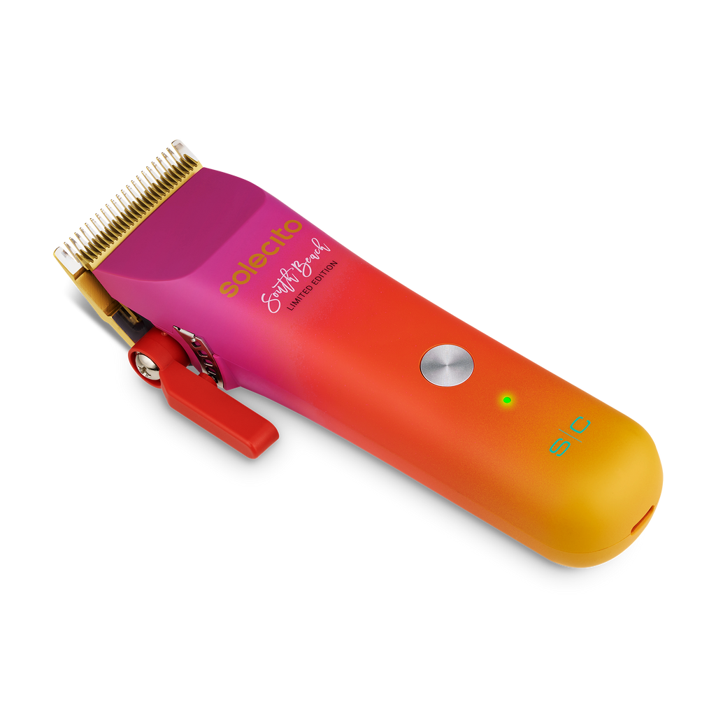 Solecito cordless clipper with gold blade and red lever, magenta-orange gradient handle