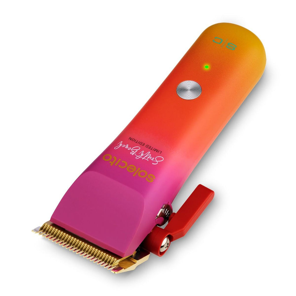 Solecito cordless clipper, slanted view, gold blade on magenta-to-orange gradient housing